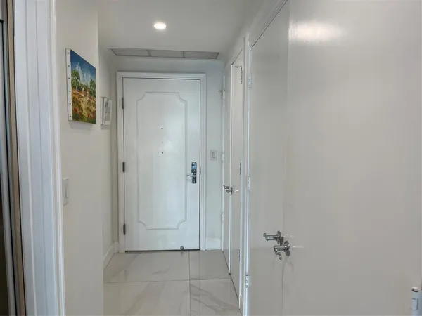 a view of a patio with couple of chairs and potted plants