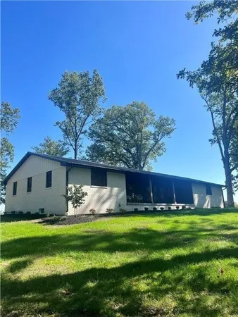 a front view of house with yard and swimming pool