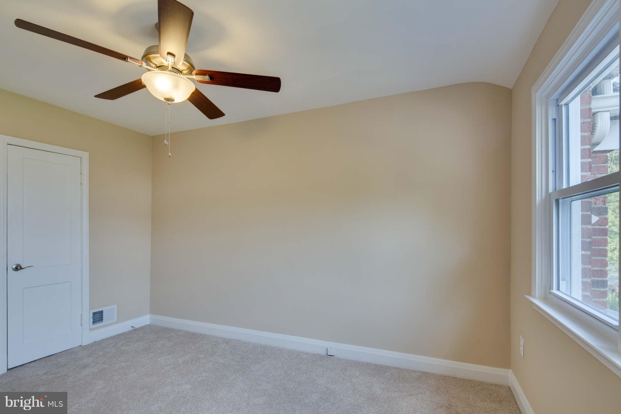 8630 Black Oak Road Baltimore, MD 21234 - Photo 22 of 30 an empty room with windows and fan