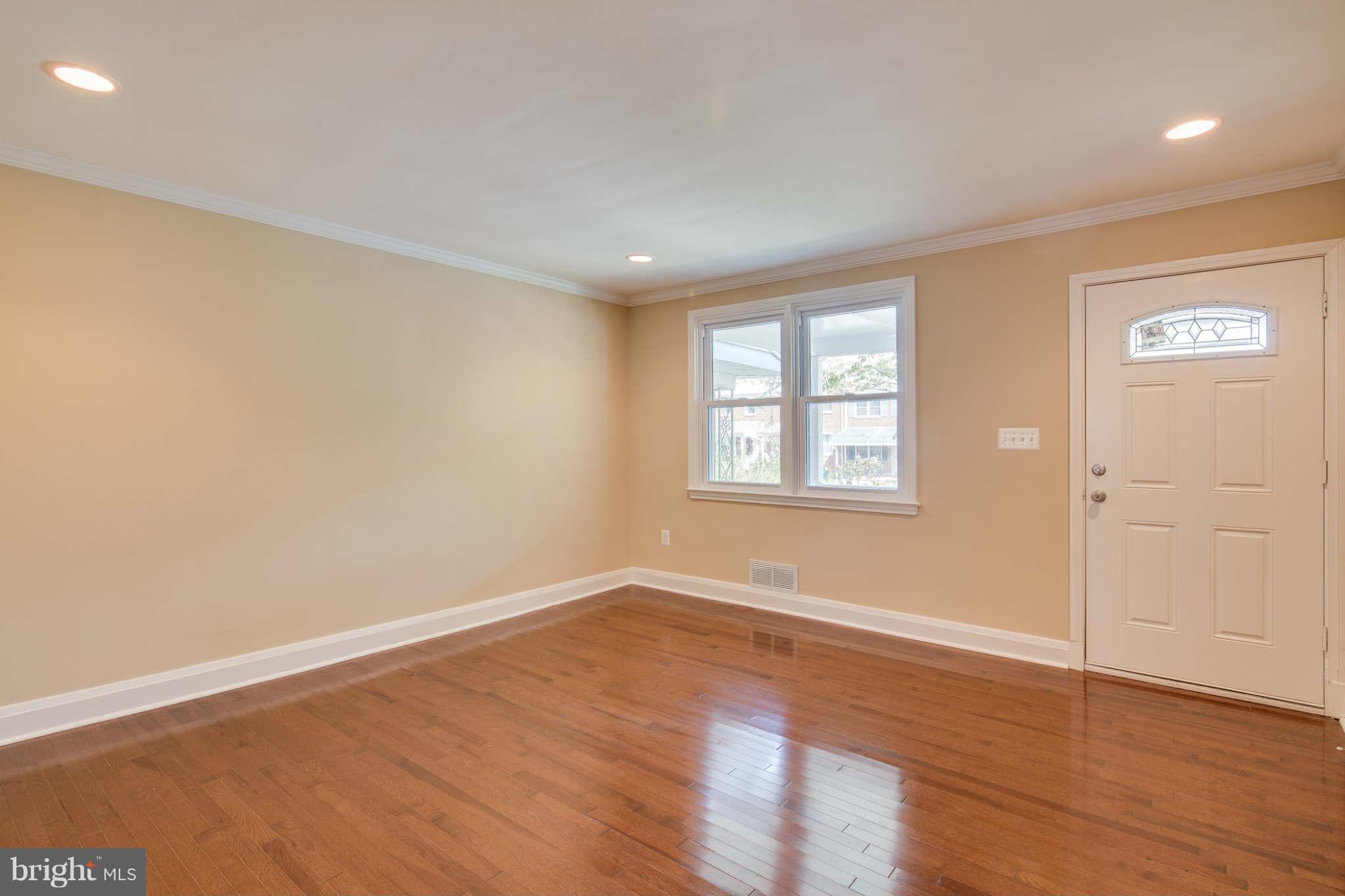 8630 Black Oak Road Baltimore, MD 21234 - Photo 8 of 30 an empty room with wooden floor and windows
