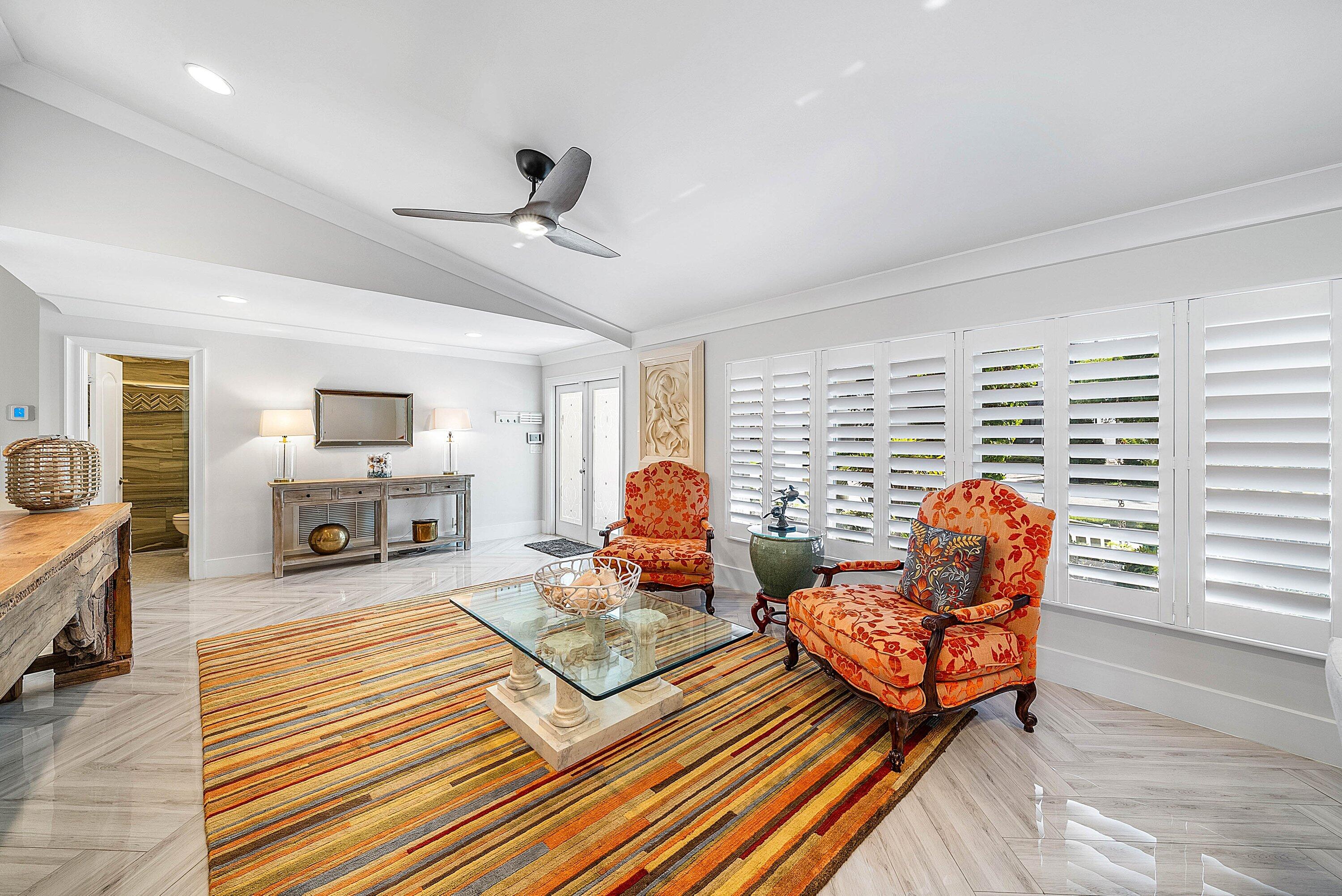 7425 Northeast Bay Cove Court Boca Raton, FL 33487 - Photo 11 of 86 a living room with furniture a fireplace and wooden floor