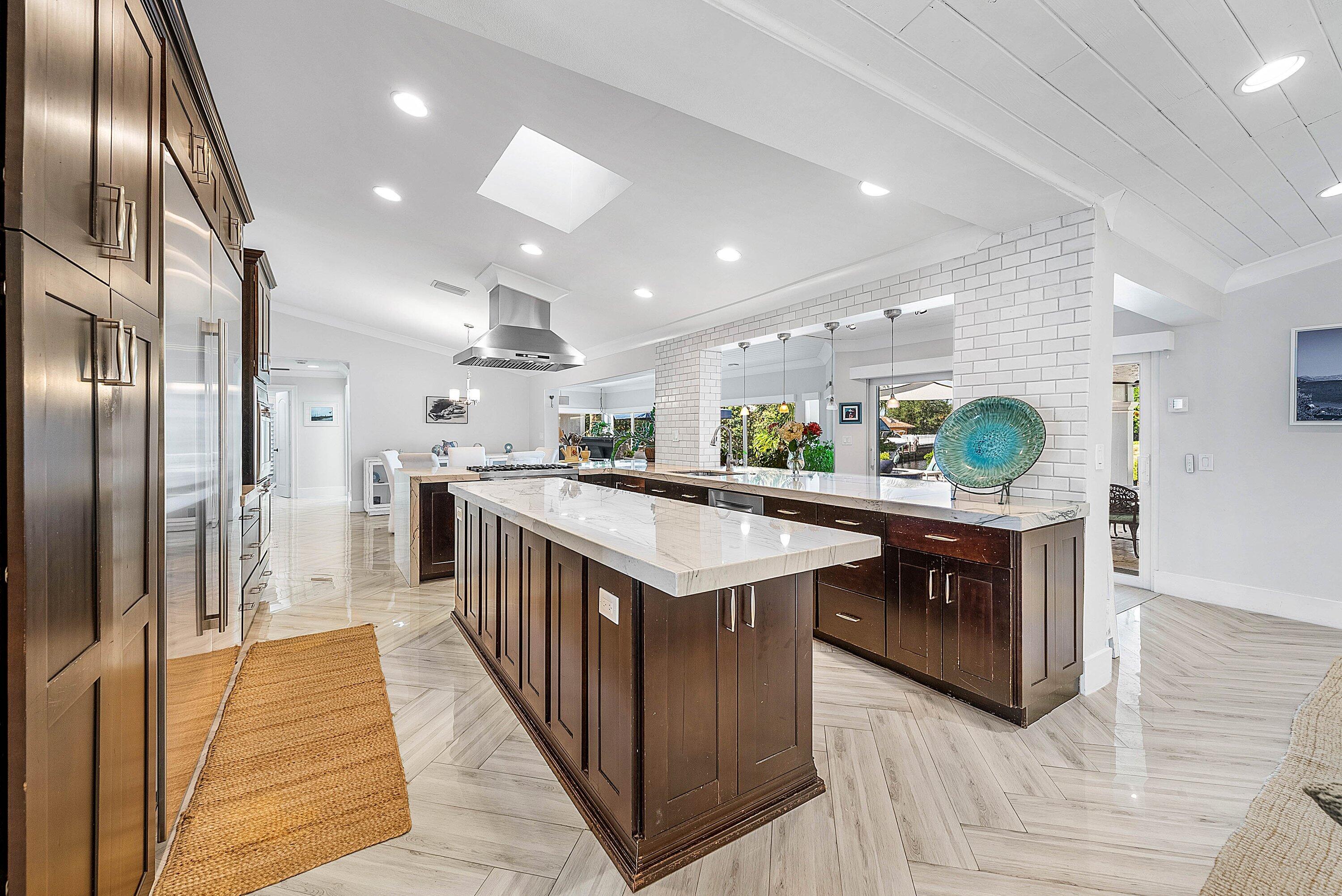 7425 Northeast Bay Cove Court Boca Raton, FL 33487 - Photo 13 of 86 a kitchen with stainless steel appliances granite countertop a table and a refrigerator