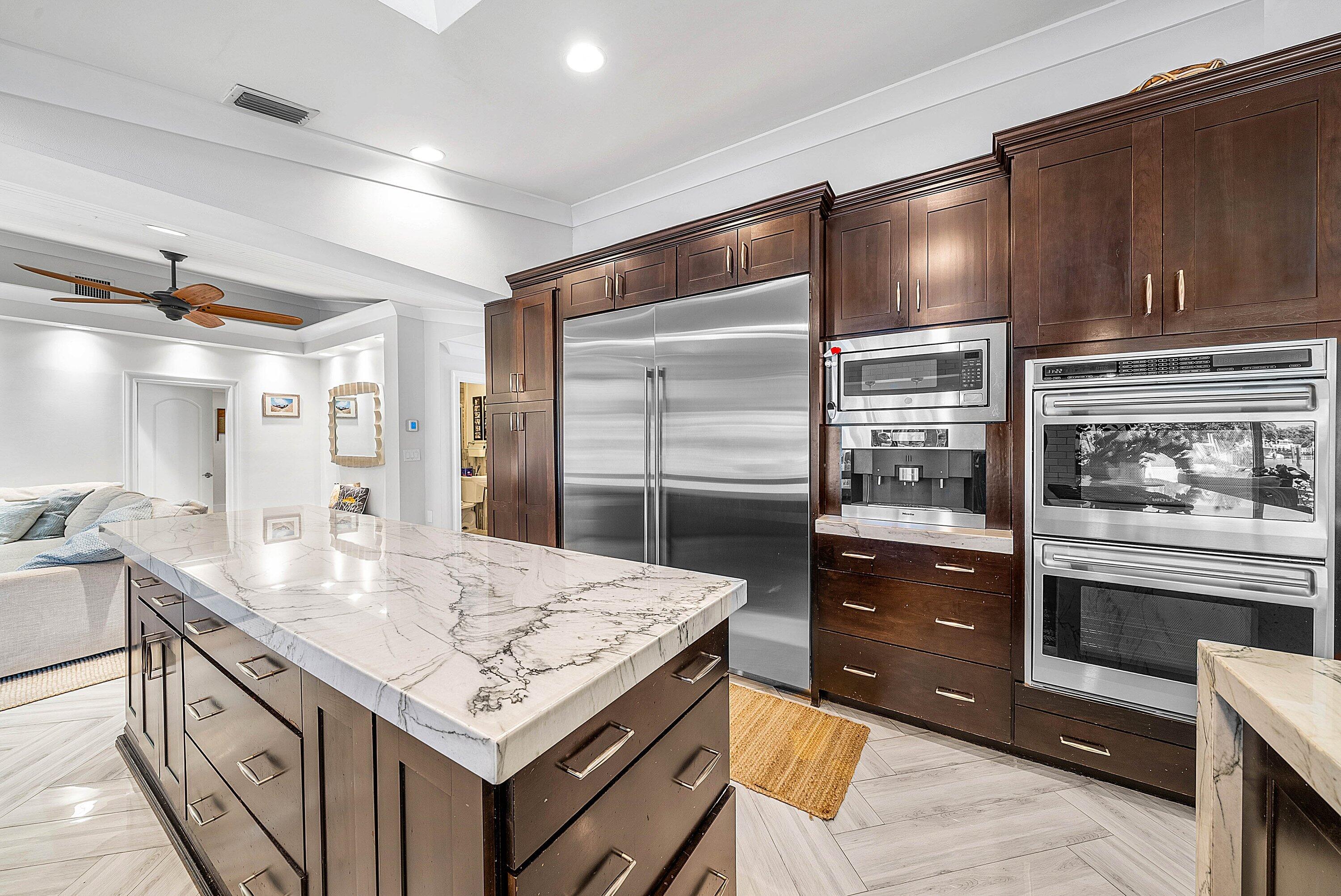 7425 Northeast Bay Cove Court Boca Raton, FL 33487 - Photo 14 of 86 a kitchen with granite countertop a stove and refrigerator