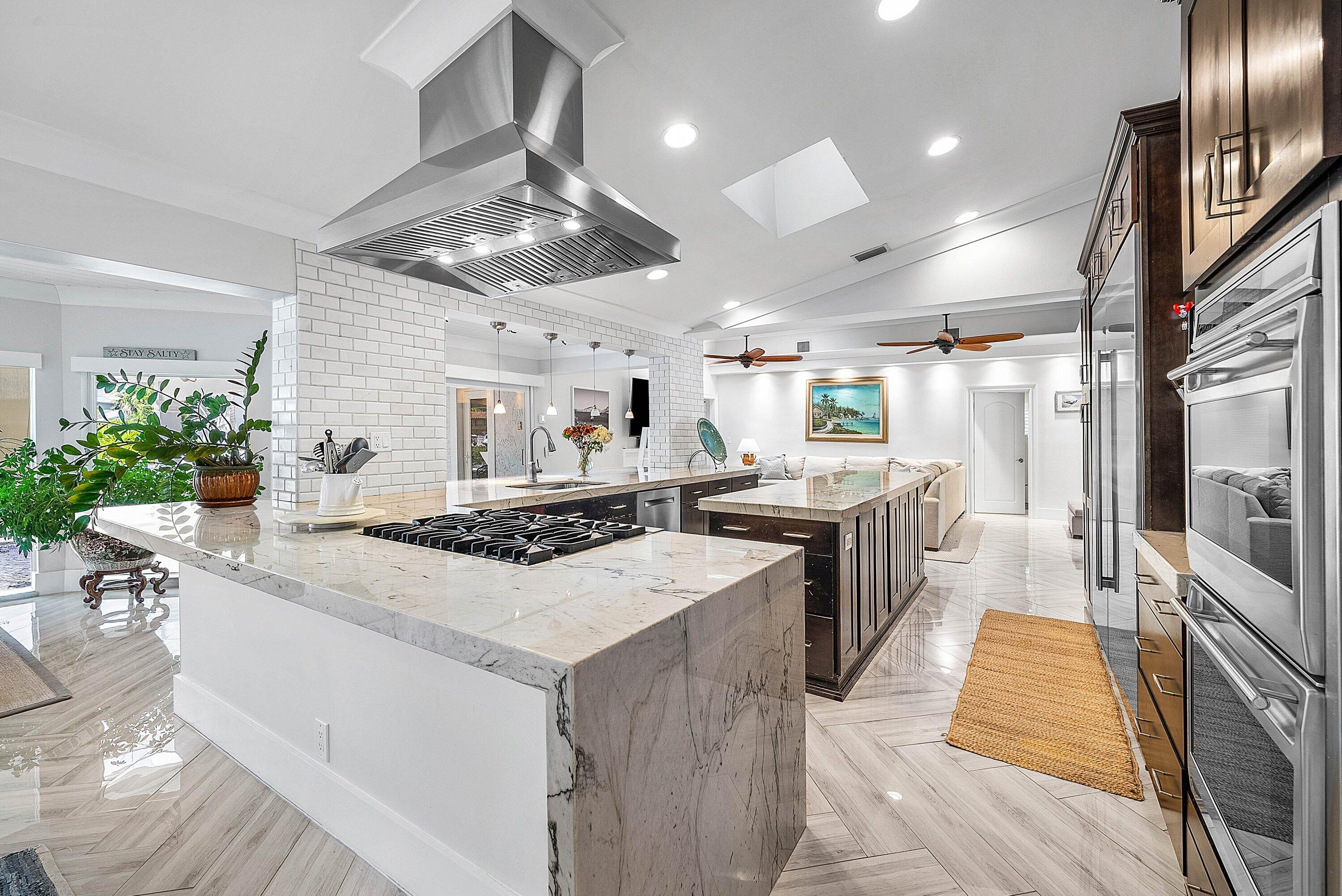 7425 Northeast Bay Cove Court Boca Raton, FL 33487 - Photo 15 of 86 a kitchen with stainless steel appliances granite countertop a sink stove and refrigerator