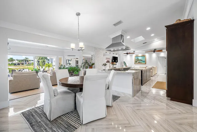 a view of a swimming pool and lounge chairs in back yard of the house