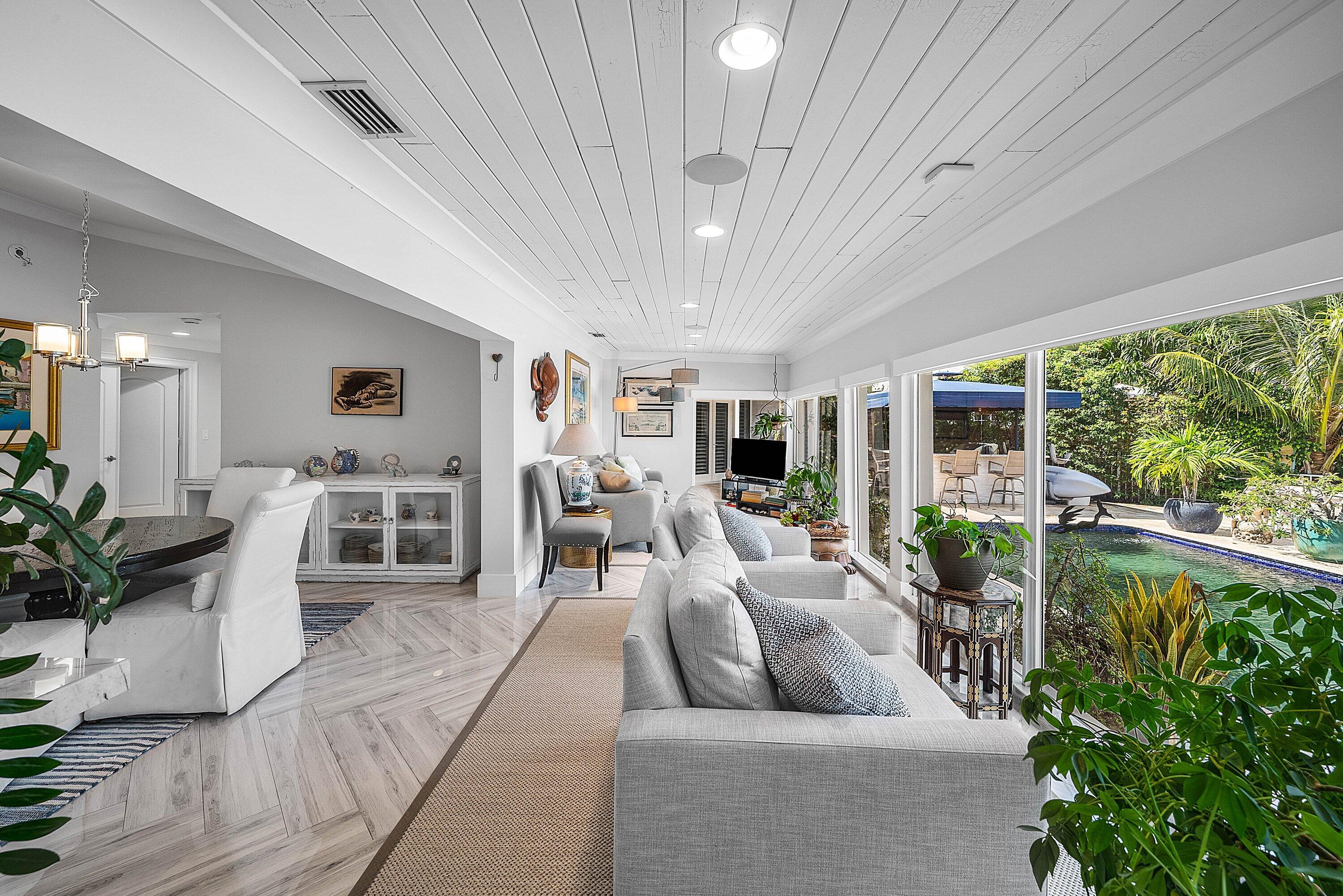 7425 Northeast Bay Cove Court Boca Raton, FL 33487 - Photo 28 of 86 a living room with furniture and a large window