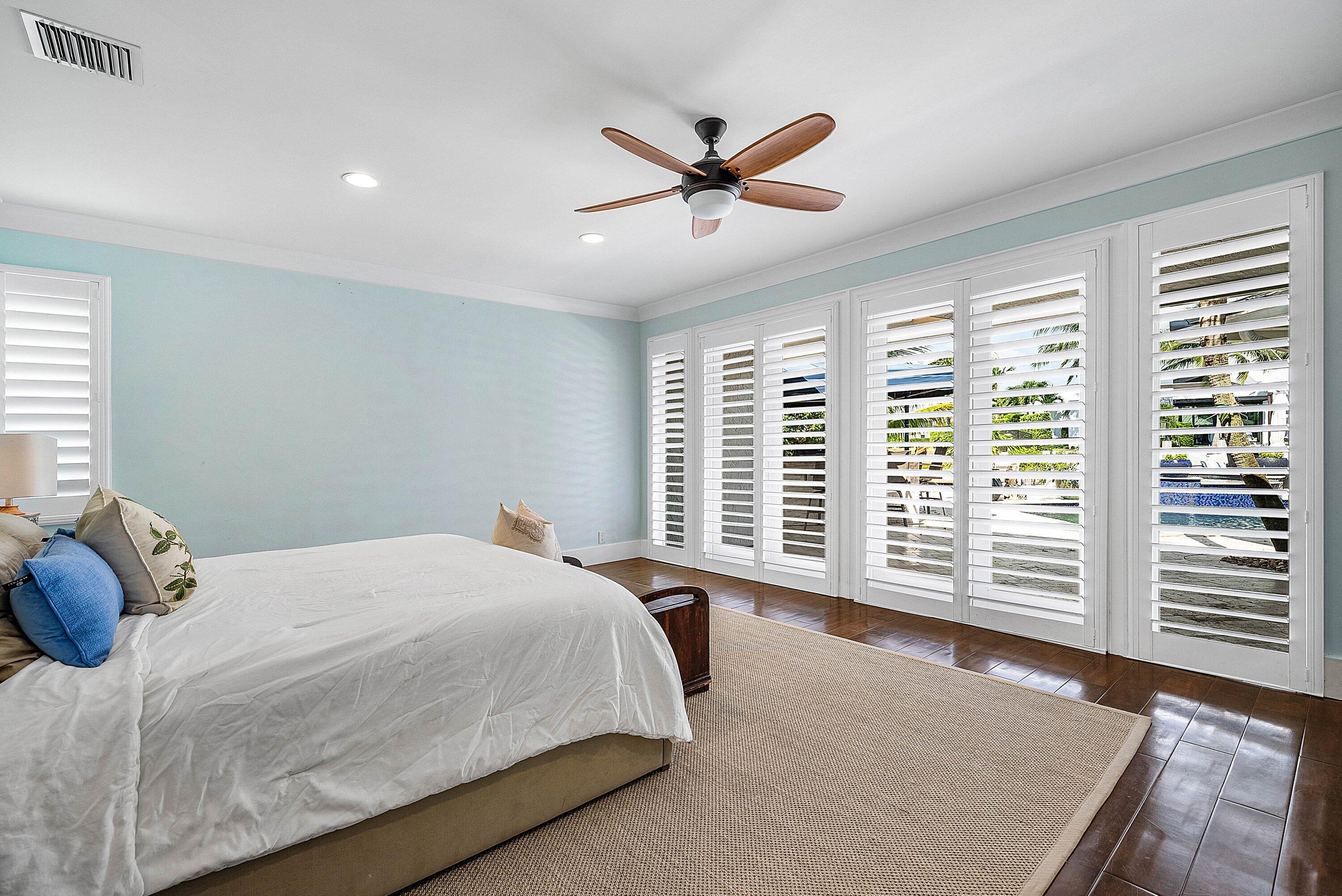 7425 Northeast Bay Cove Court Boca Raton, FL 33487 - Photo 35 of 86 a bedroom with a large bed and a large window