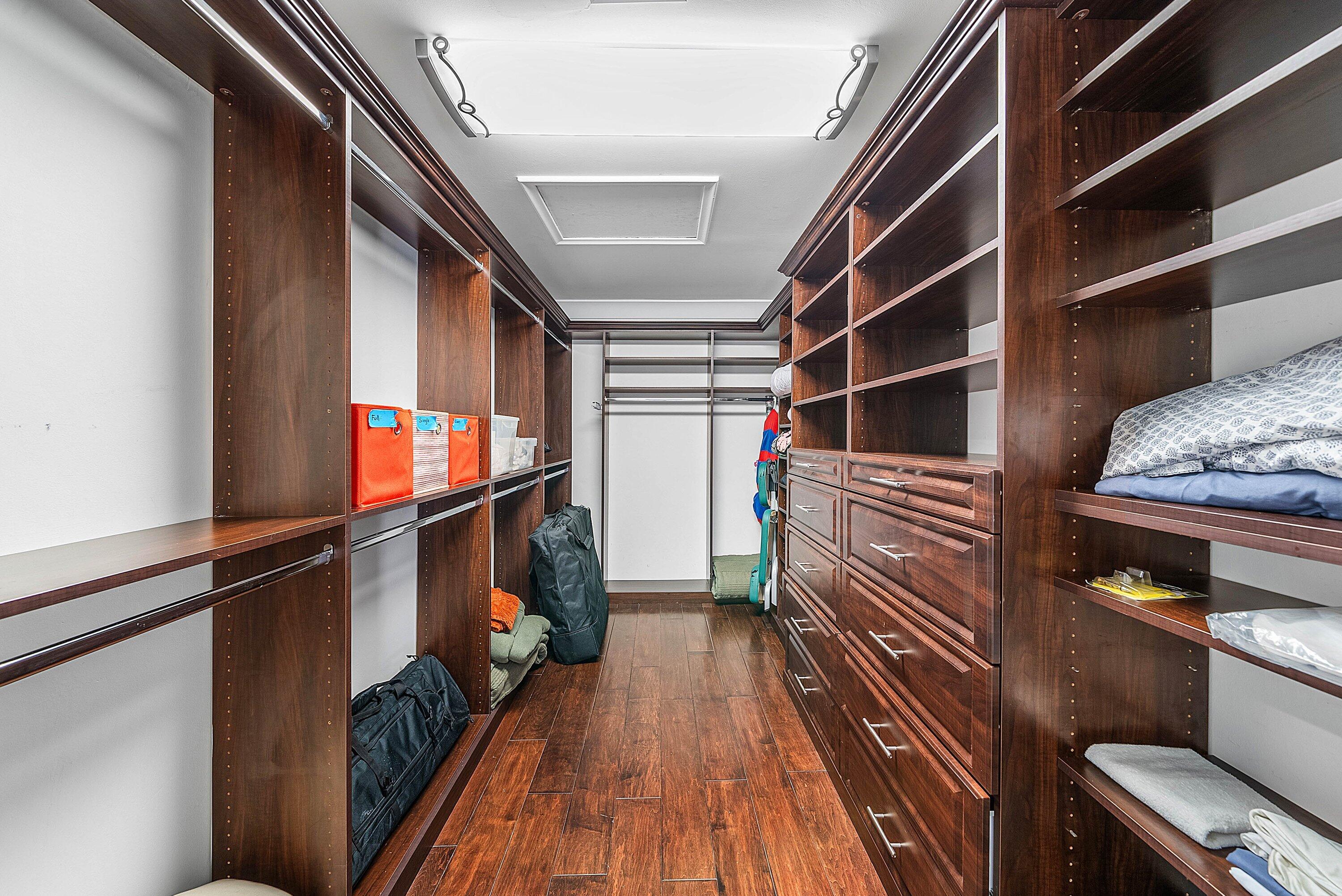 7425 Northeast Bay Cove Court Boca Raton, FL 33487 - Photo 43 of 86 a view of walk in closet with clothes and shoes