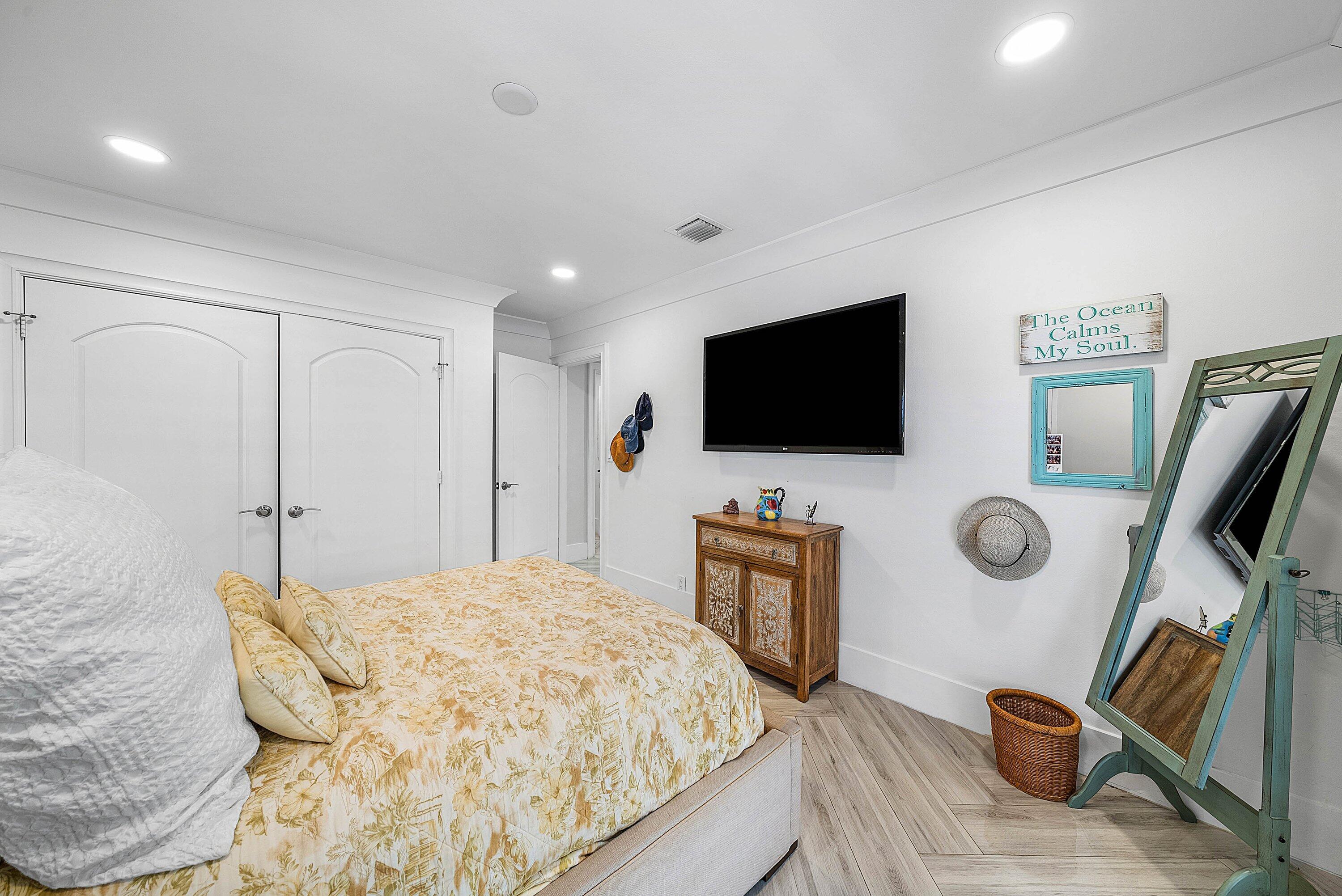 7425 Northeast Bay Cove Court Boca Raton, FL 33487 - Photo 60 of 86 a bedroom with a bed and flat screen tv