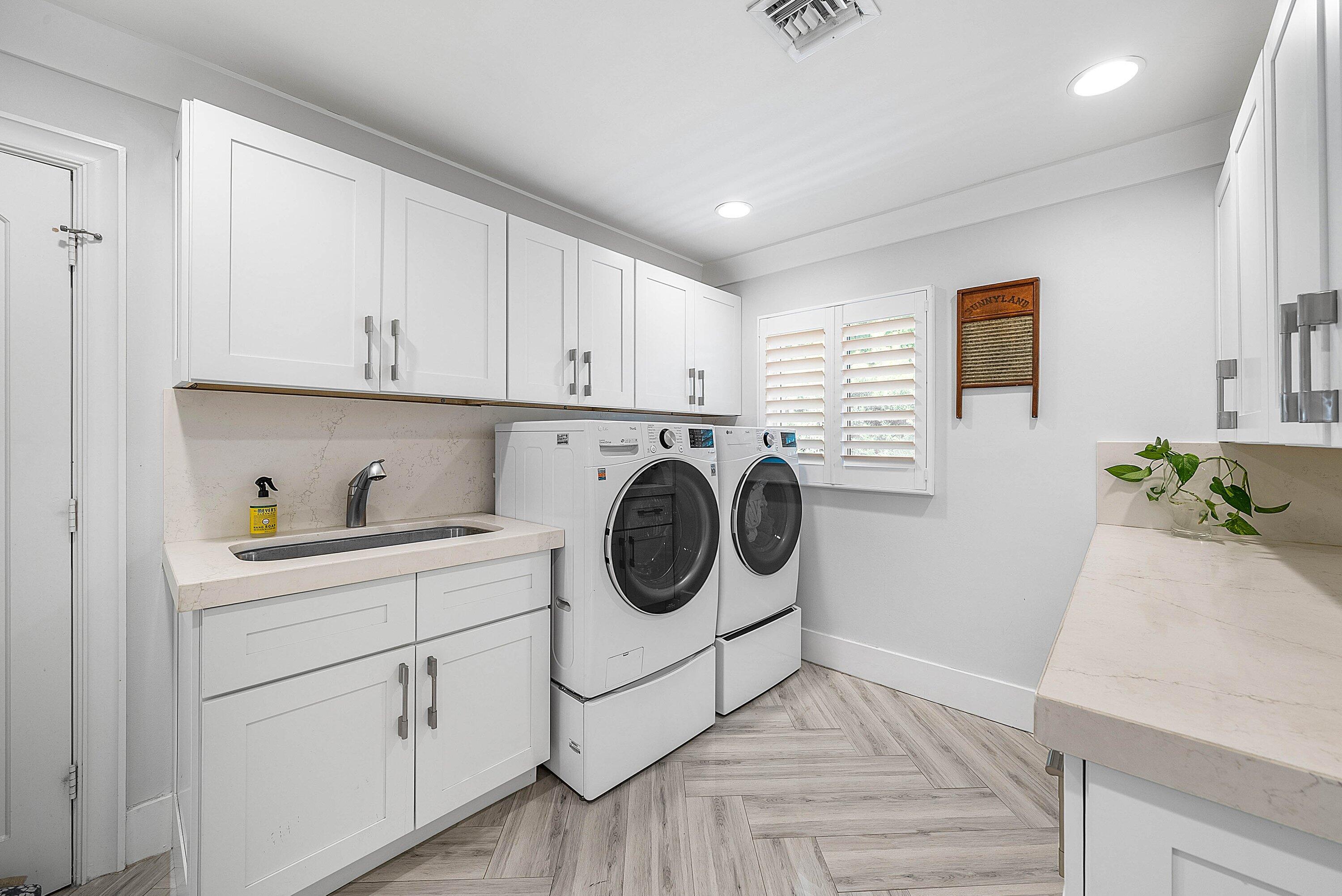 7425 Northeast Bay Cove Court Boca Raton, FL 33487 - Photo 62 of 86 a utility room with sink dryer and washer