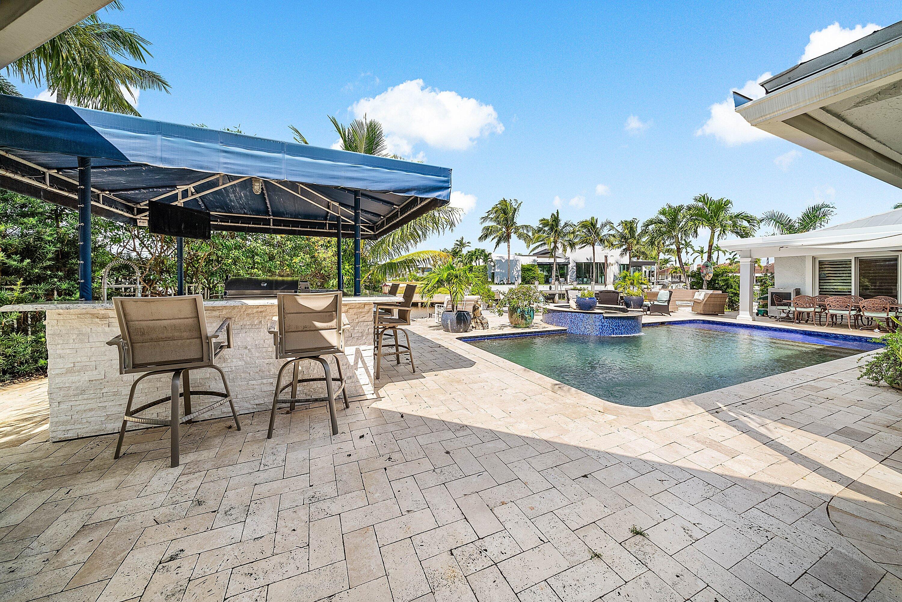 7425 Northeast Bay Cove Court Boca Raton, FL 33487 - Photo 66 of 86 a view of a swimming pool with a patio