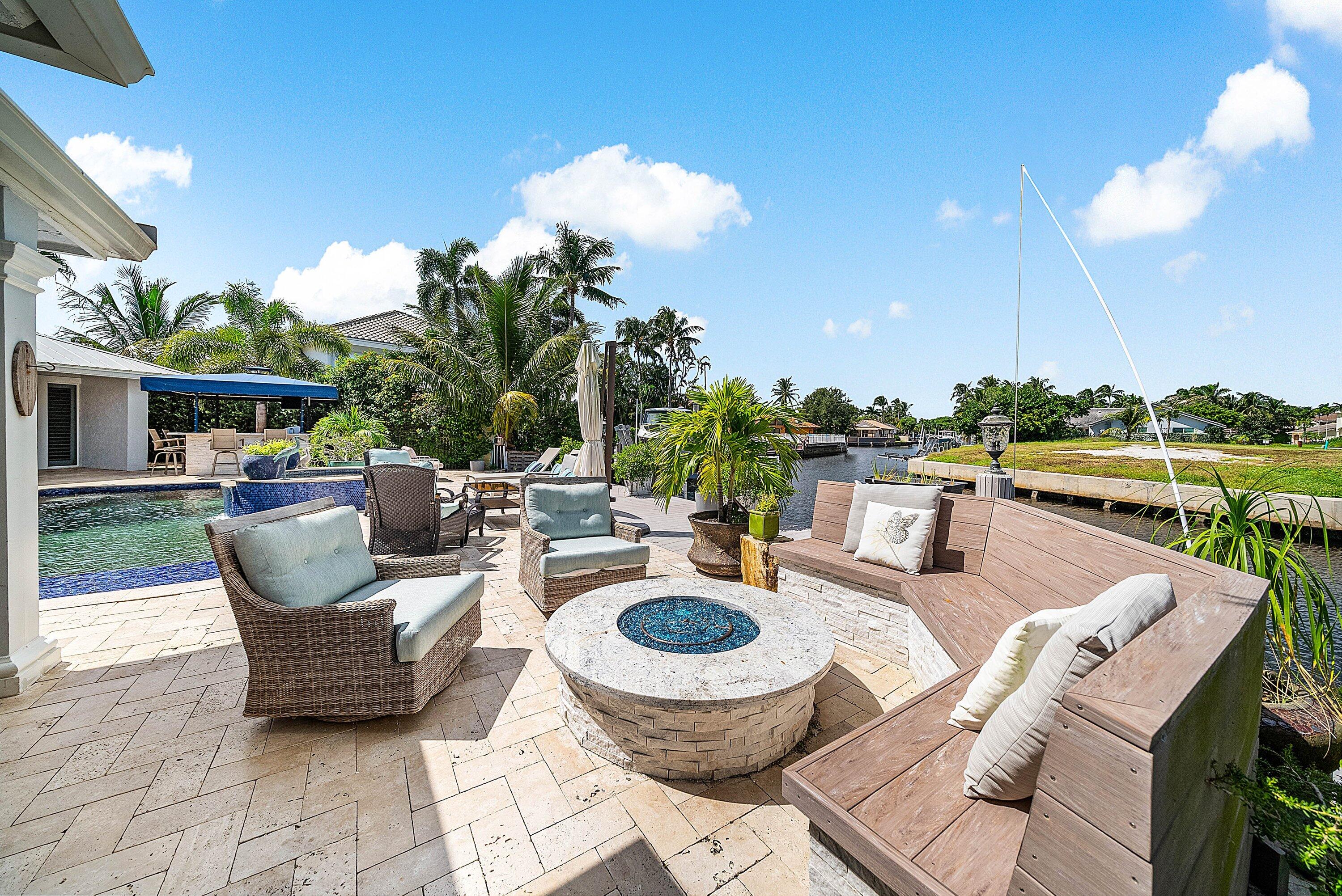 7425 Northeast Bay Cove Court Boca Raton, FL 33487 - Photo 69 of 86 a view of a patio with couches table and chairs and potted plants