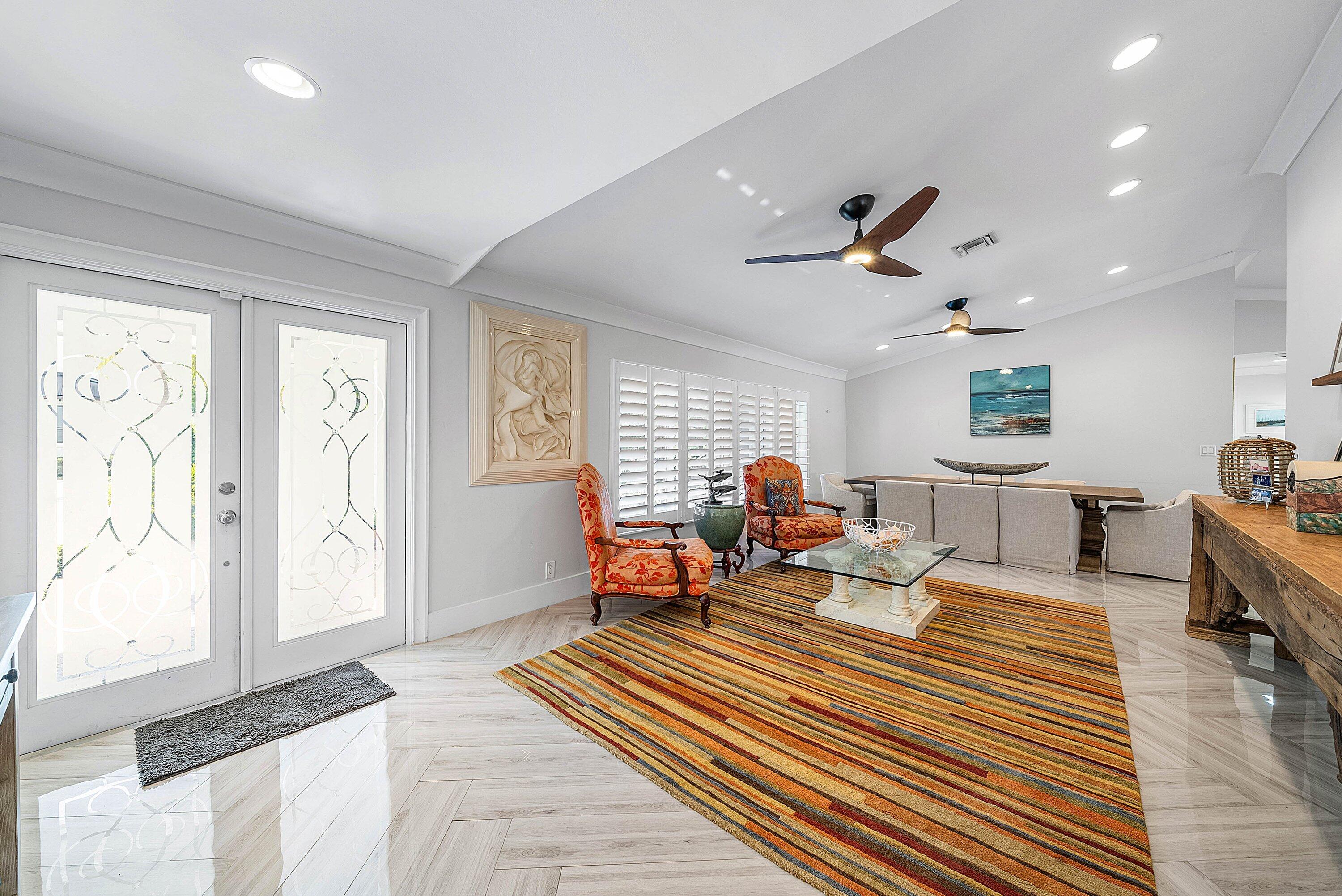 7425 Northeast Bay Cove Court Boca Raton, FL 33487 - Photo 8 of 86 a living room with furniture a window and gym equipment