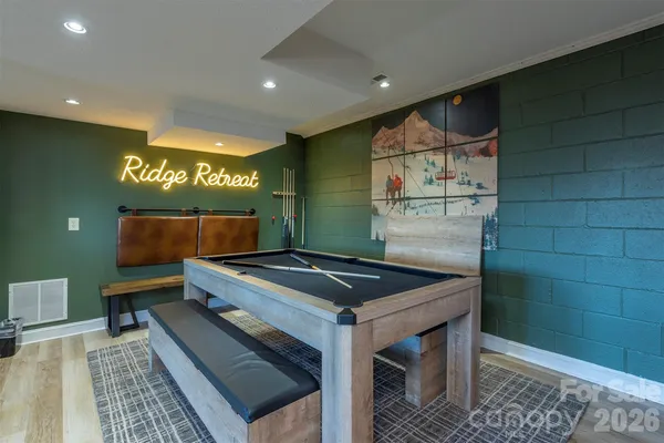 a room with pool table and windows