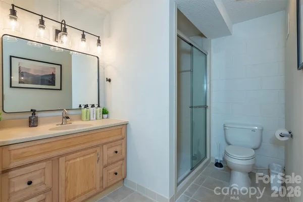 a bathroom with a shower and a sink