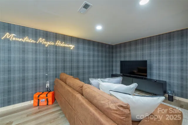 a living room with furniture and a flat screen tv