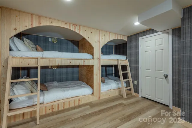 a view of a hallway with entryway and chandelier