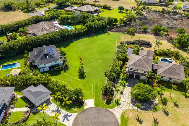 an aerial view of residential house with outdoor space and swimming pool