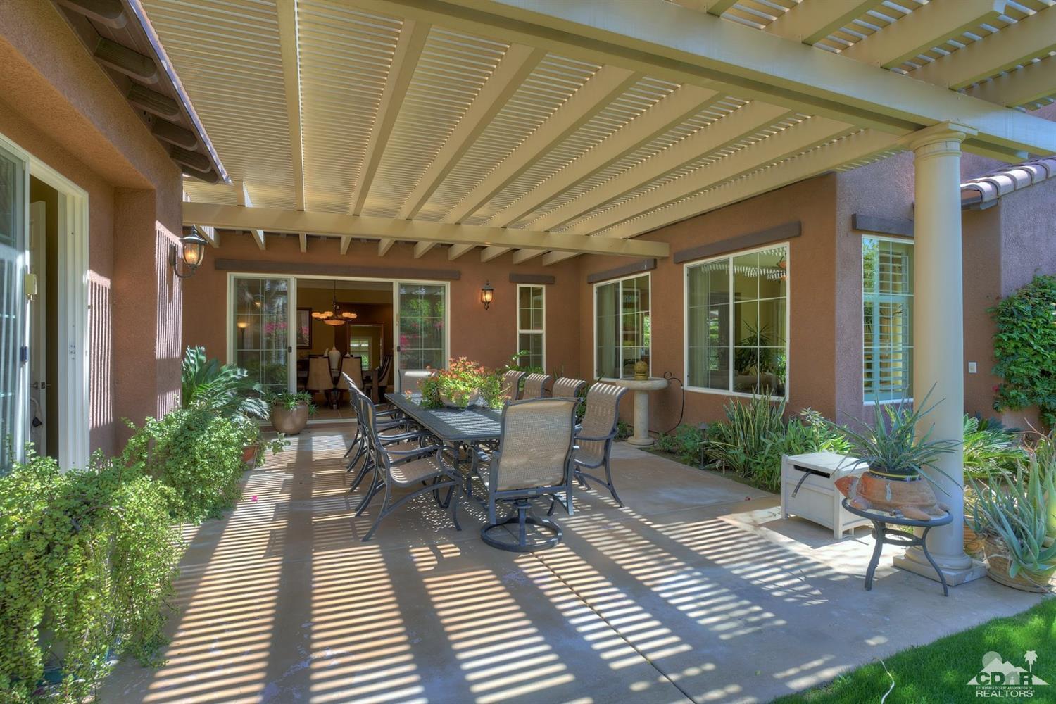 5 Via Santa Velera Rancho Mirage, CA 92270 - Photo 22 of 90 a view of a patio with table and chairs and potted plants