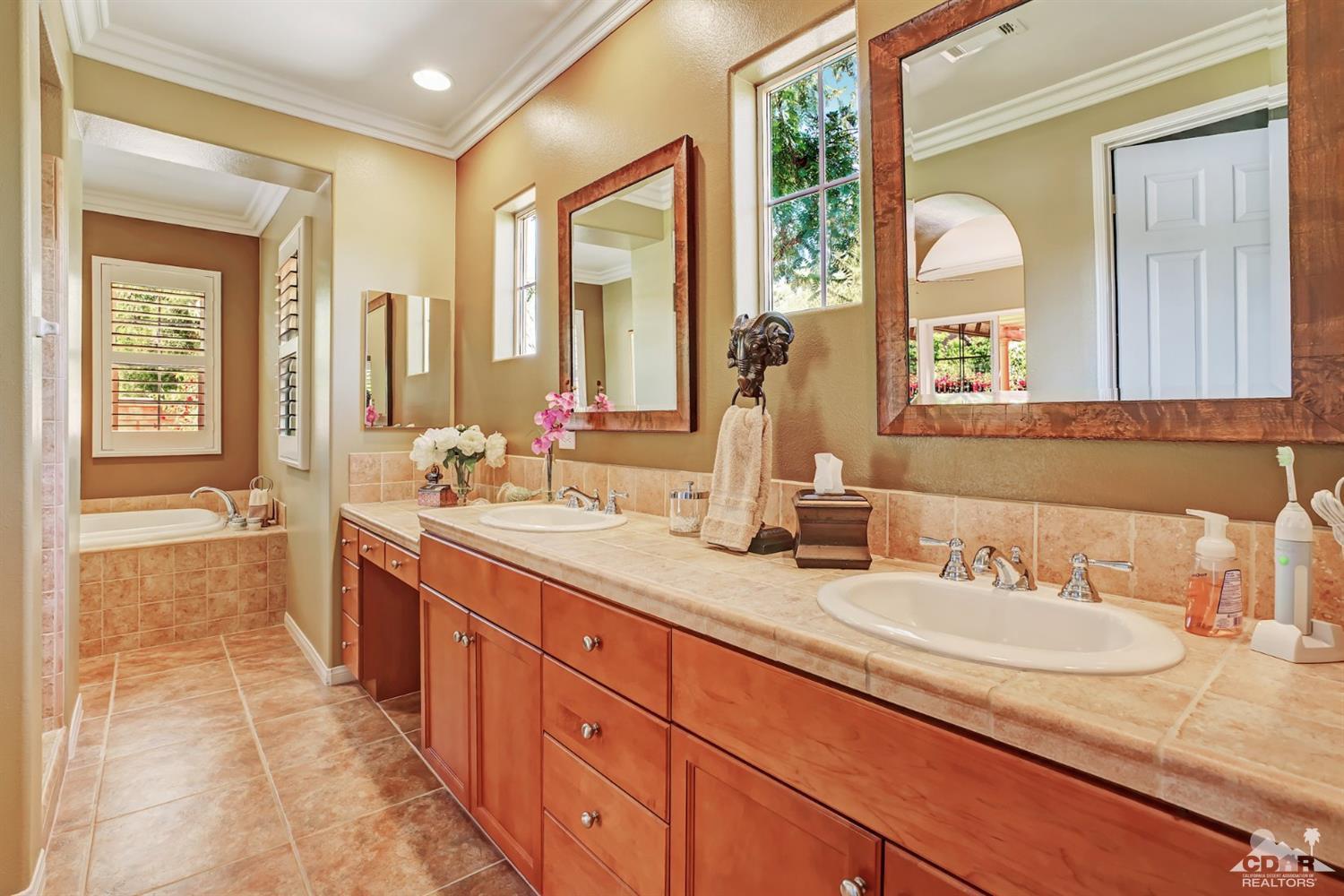 5 Via Santa Velera Rancho Mirage, CA 92270 - Photo 29 of 90 a bathroom with a granite countertop sink and a large mirror