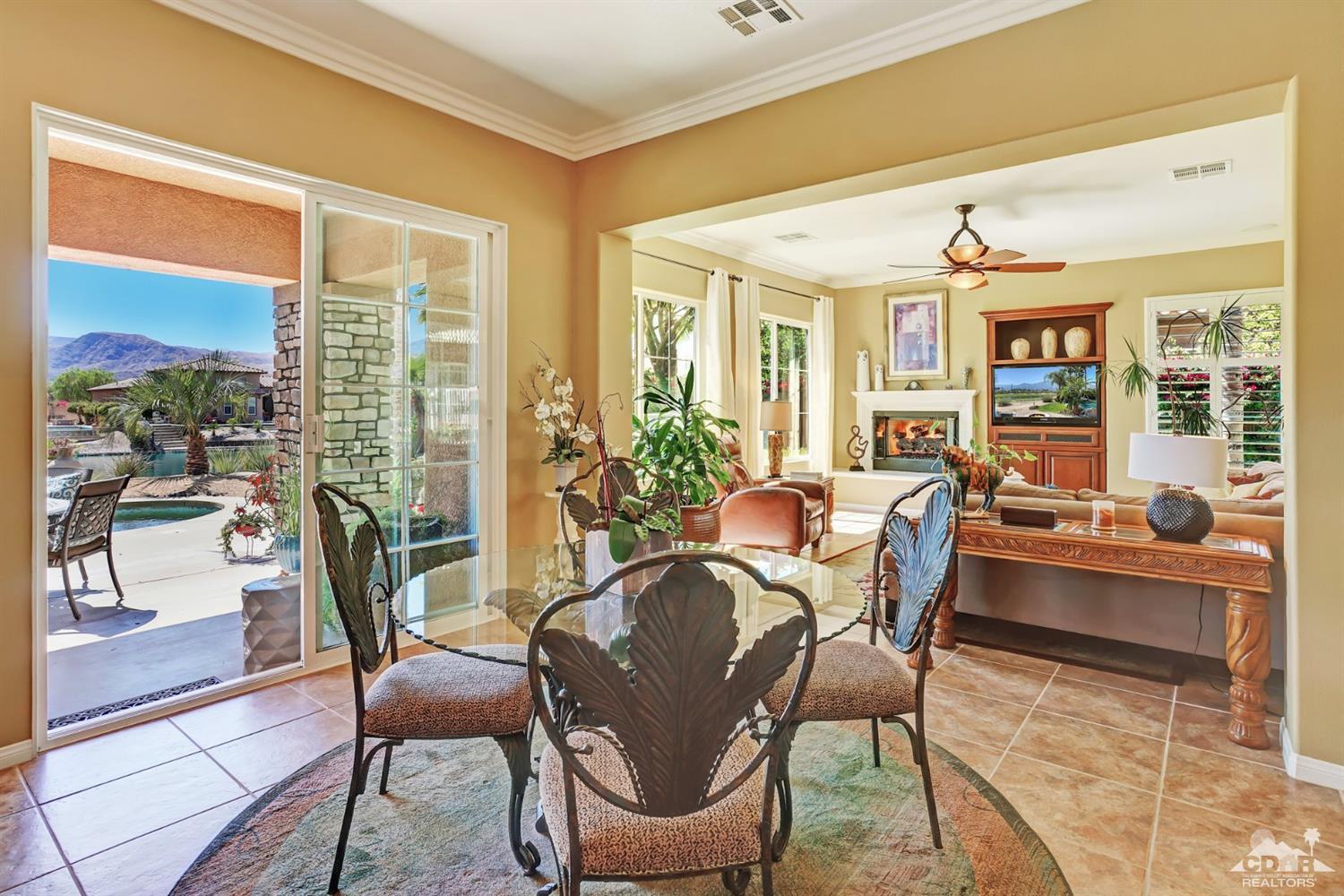 5 Via Santa Velera Rancho Mirage, CA 92270 - Photo 39 of 90 a view of a dining room with furniture large windows and wooden floor