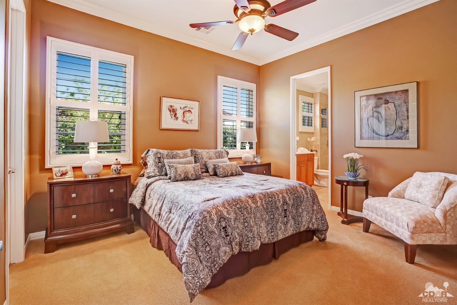 5 Via Santa Velera Rancho Mirage, CA 92270 - Photo 43 of 90 a spacious bedroom with a bed and a chandelier