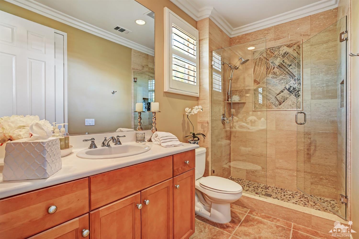 5 Via Santa Velera Rancho Mirage, CA 92270 - Photo 44 of 90 a bathroom with a granite countertop sink toilet a mirror a shower and a sink