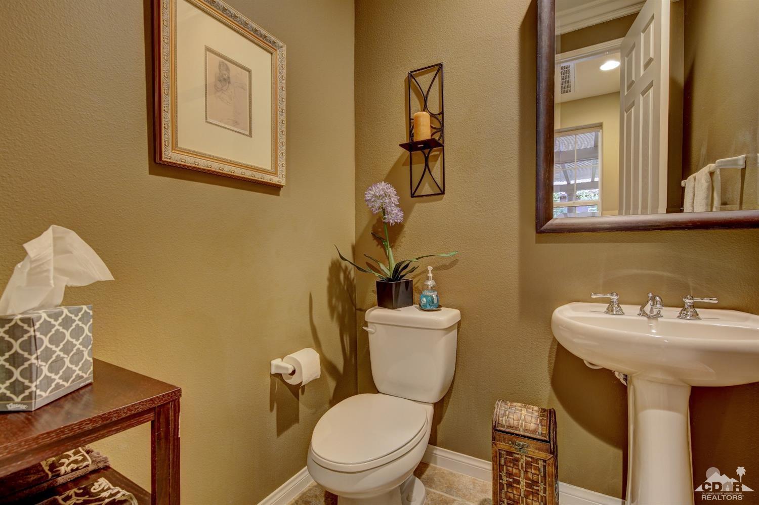 5 Via Santa Velera Rancho Mirage, CA 92270 - Photo 47 of 90 a bathroom with a toilet a sink and mirror
