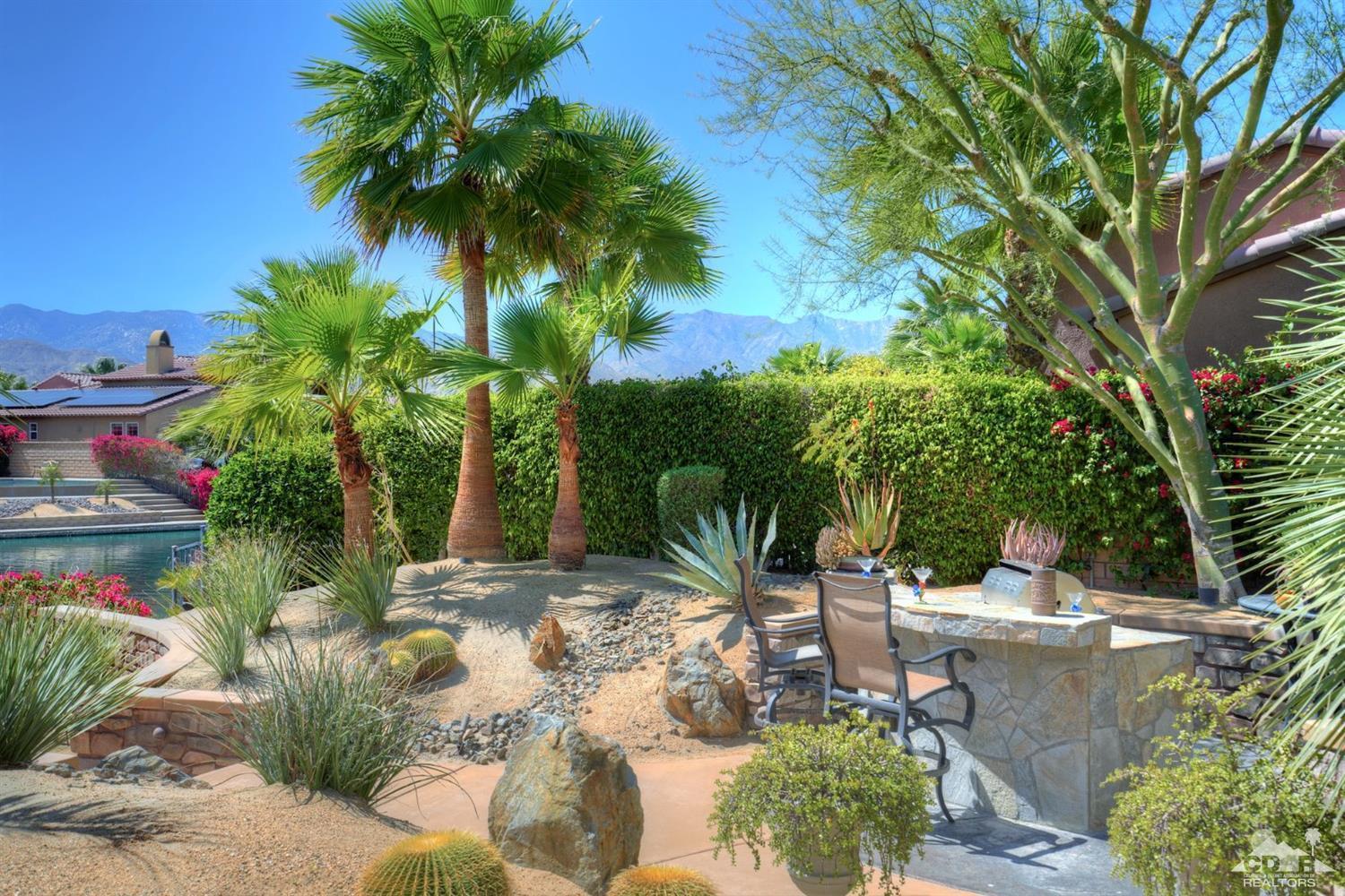 5 Via Santa Velera Rancho Mirage, CA 92270 - Photo 81 of 90 a view of a backyard with potted plants and large trees