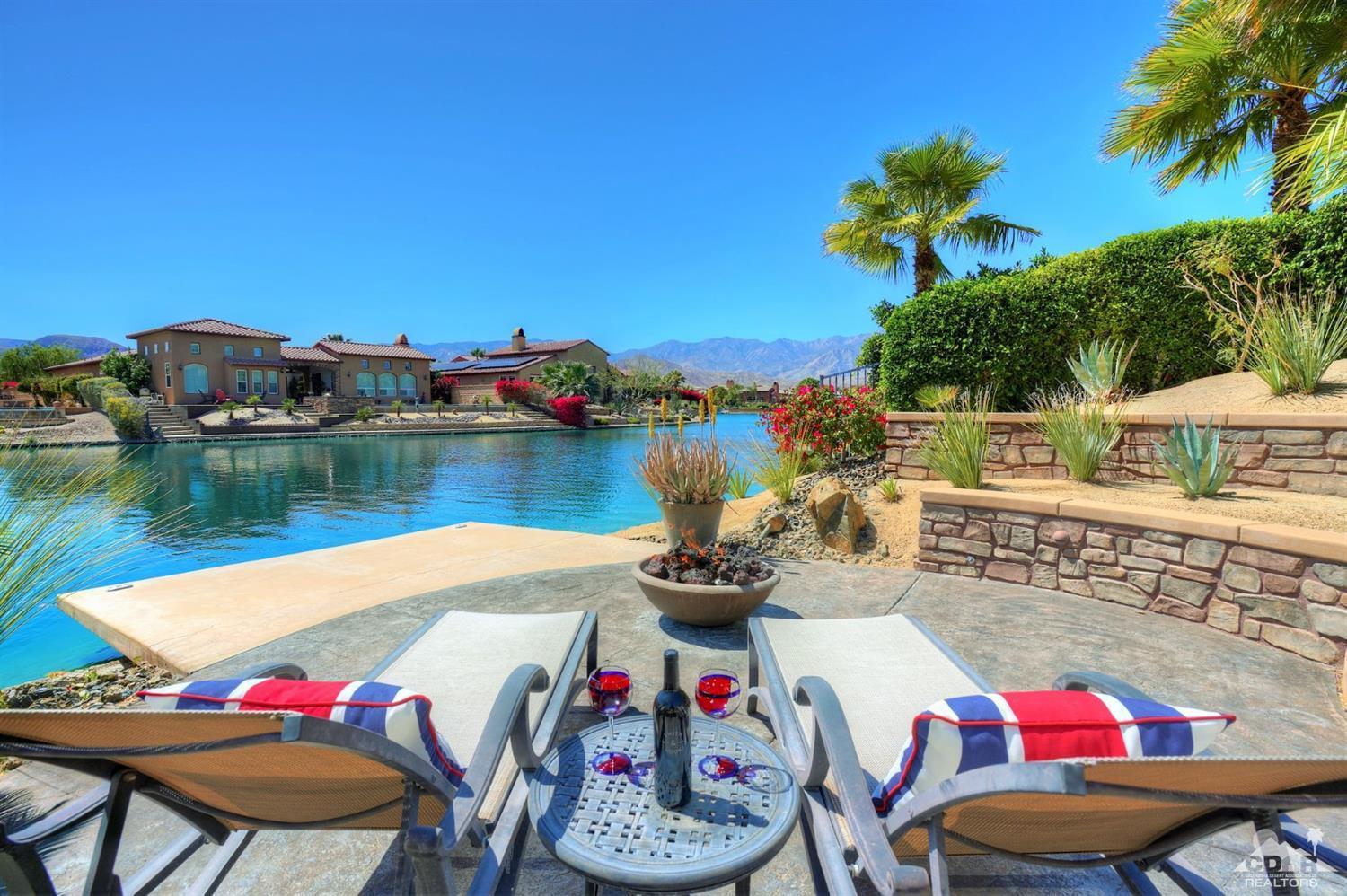 5 Via Santa Velera Rancho Mirage, CA 92270 - Photo 84 of 90 a view of swimming pool with a table and chairs in front of it