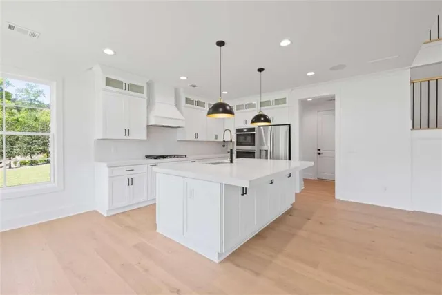 an empty room with windows and fireplace