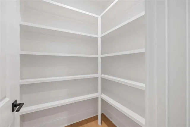 a view of an empty room with a ceiling fan