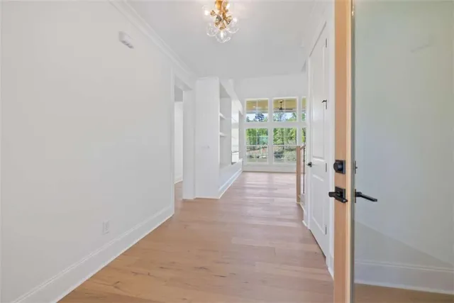 en empty room with windows and fan