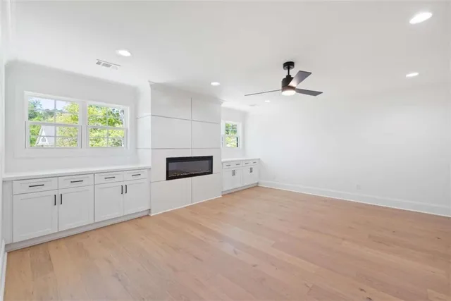 an aerial view of lake and residential houses with outdoor space and trees