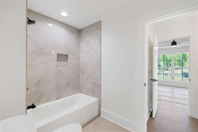 an aerial view of residential houses with outdoor space and trees