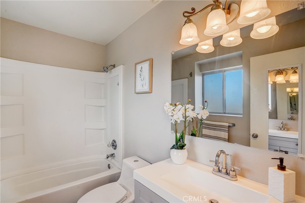 39429 Long Ridge Drive Temecula, CA 92591 - Photo 11 of 23 a bathroom with a granite countertop sink a toilet and a mirror
