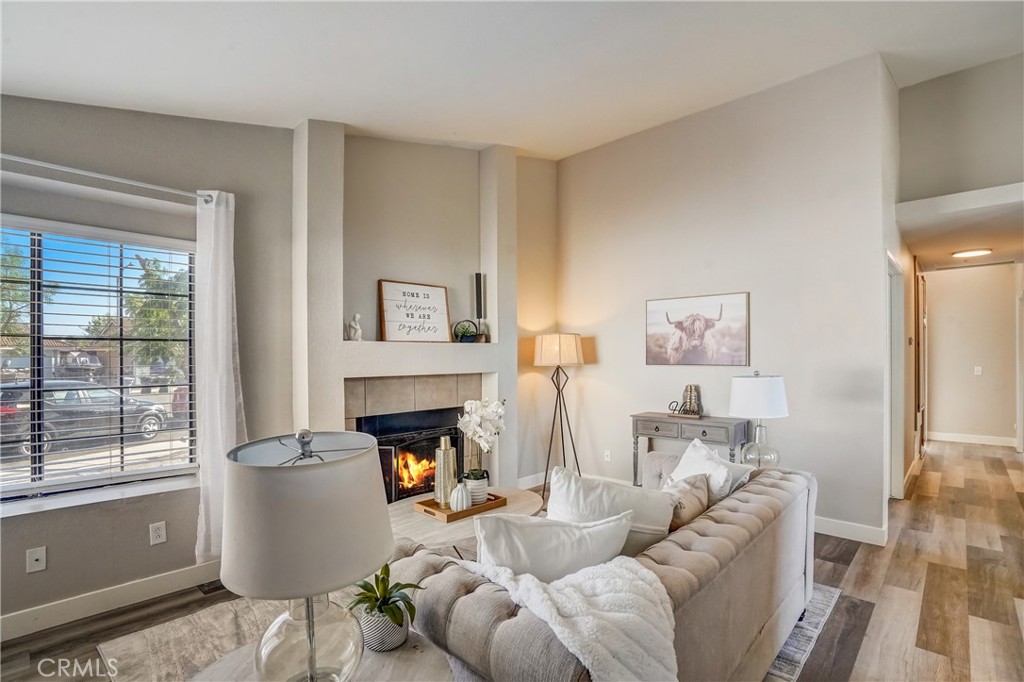 39429 Long Ridge Drive Temecula, CA 92591 - Photo 3 of 23 a living room with furniture a large window and a fireplace
