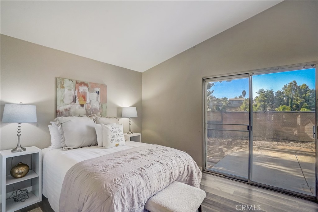 39429 Long Ridge Drive Temecula, CA 92591 - Photo 9 of 23 a bedroom with a balcony a bed and a lamp