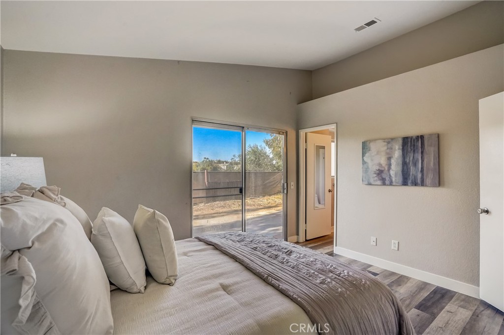 39429 Long Ridge Drive Temecula, CA 92591 - Photo 10 of 23 a bedroom with a bed and glass door
