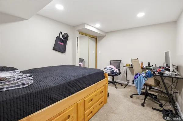 a bedroom with a bed and a couch