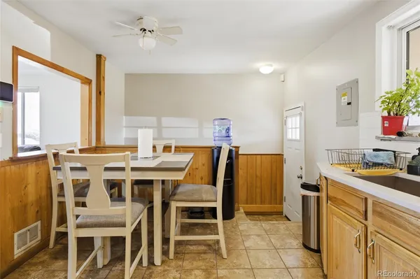 a view of a dining room with furniture and a chandelier