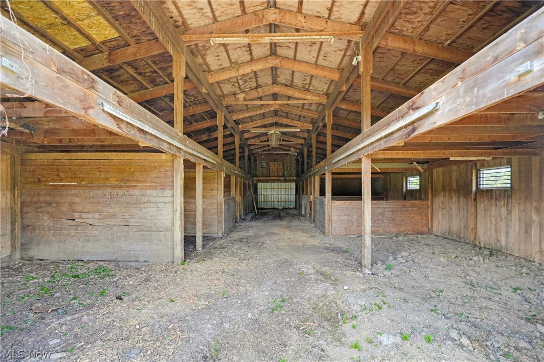 82 State Route Newton Falls, OH 44444 - Photo 9 of 30 Expansive barn structure featuring exposed wood beams, wood-plank walls, and multiple stalls