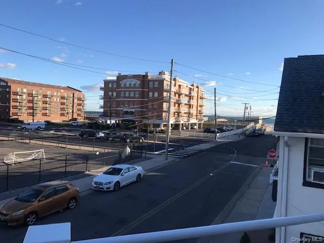a city view with lot of cars parked on road