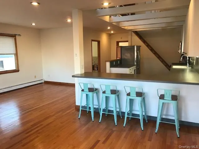 a dining room with furniture and wooden floor