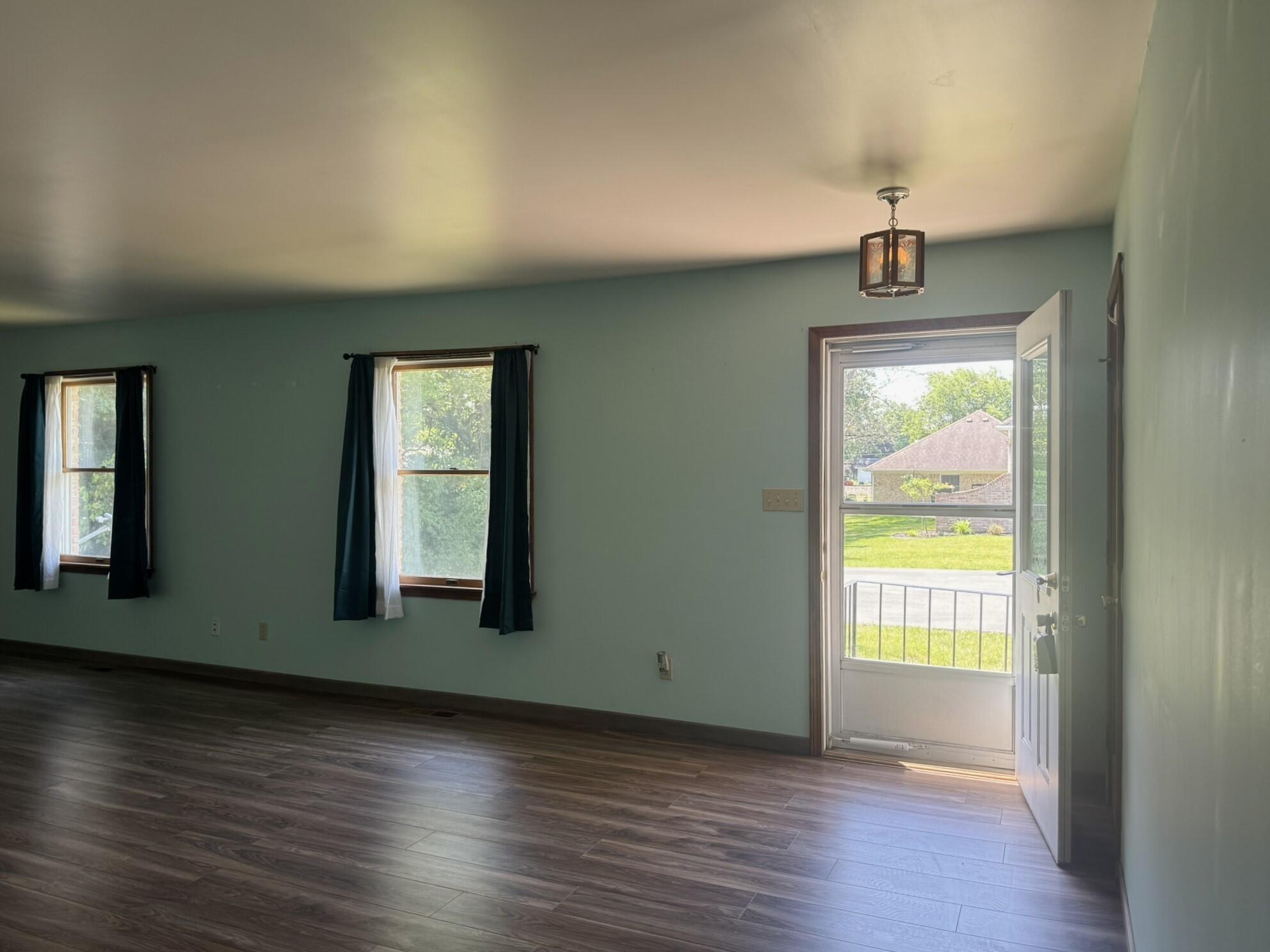 641 D Begonia Street Southeast De Motte, IN 46310 - Photo 12 of 39 a view of an empty room with wooden floor and a window