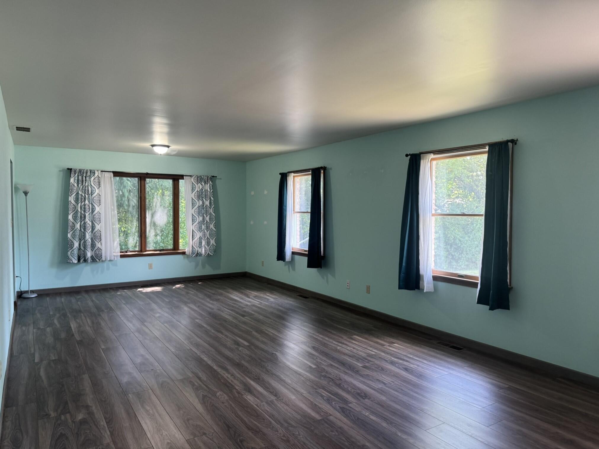 641 D Begonia Street Southeast De Motte, IN 46310 - Photo 13 of 39 a view of an empty room with wooden floor and a window