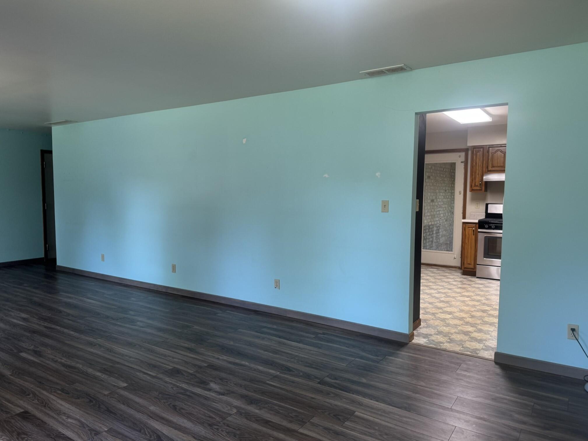 641 D Begonia Street Southeast De Motte, IN 46310 - Photo 15 of 39 a view of an empty room with wooden floor