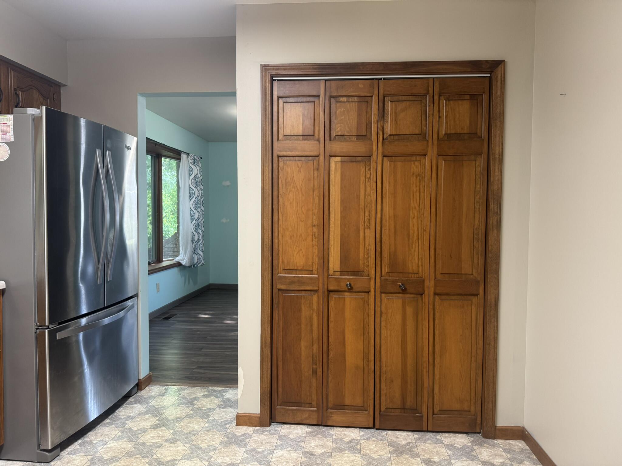641 D Begonia Street Southeast De Motte, IN 46310 - Photo 16 of 39 a view of a refrigerator in kitchen and wooden floor