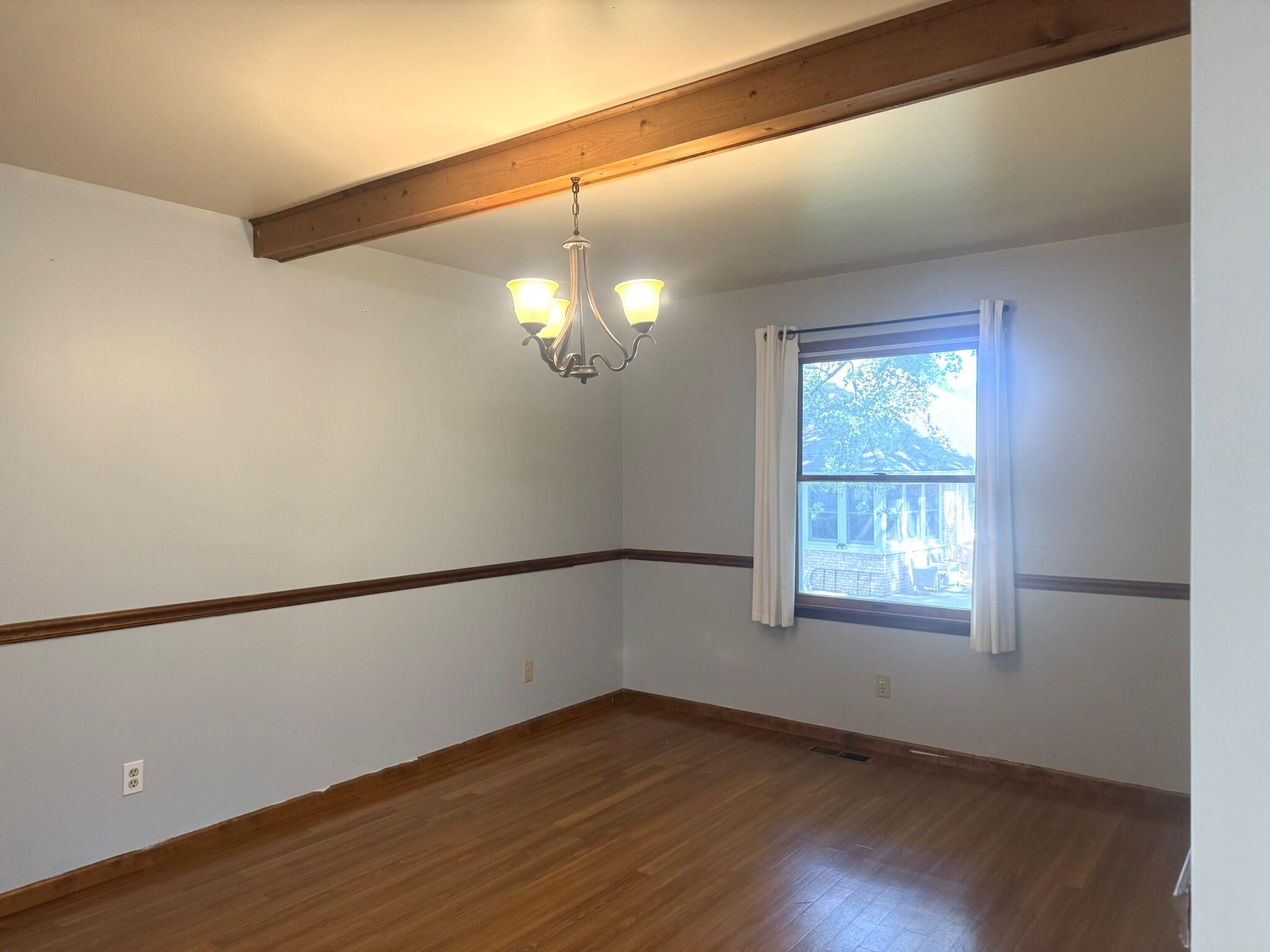 641 D Begonia Street Southeast De Motte, IN 46310 - Photo 22 of 39 a view of an empty room with wooden floor and a window