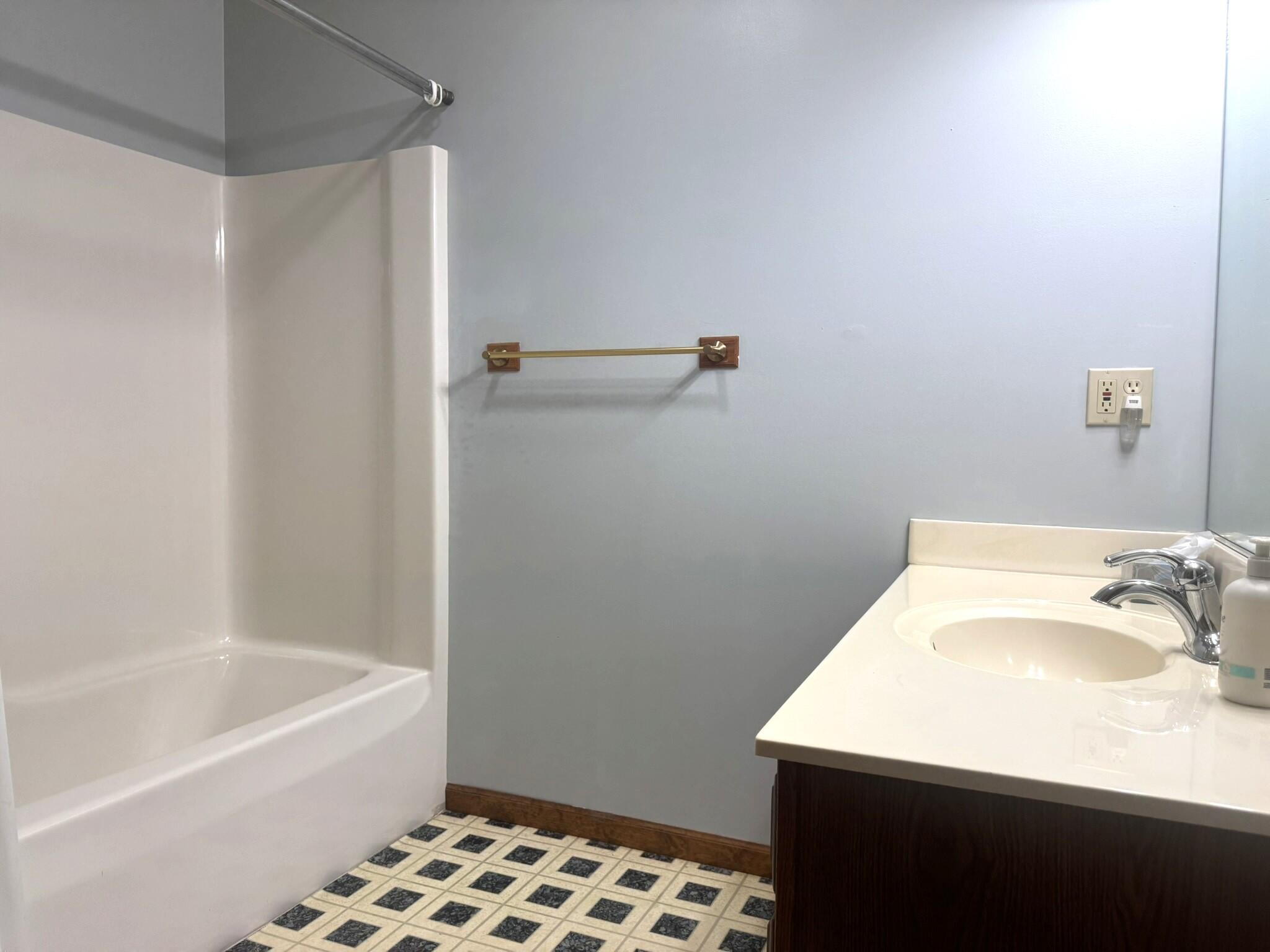 641 D Begonia Street Southeast De Motte, IN 46310 - Photo 27 of 39 a bathroom with a sink a bath tub and a shower